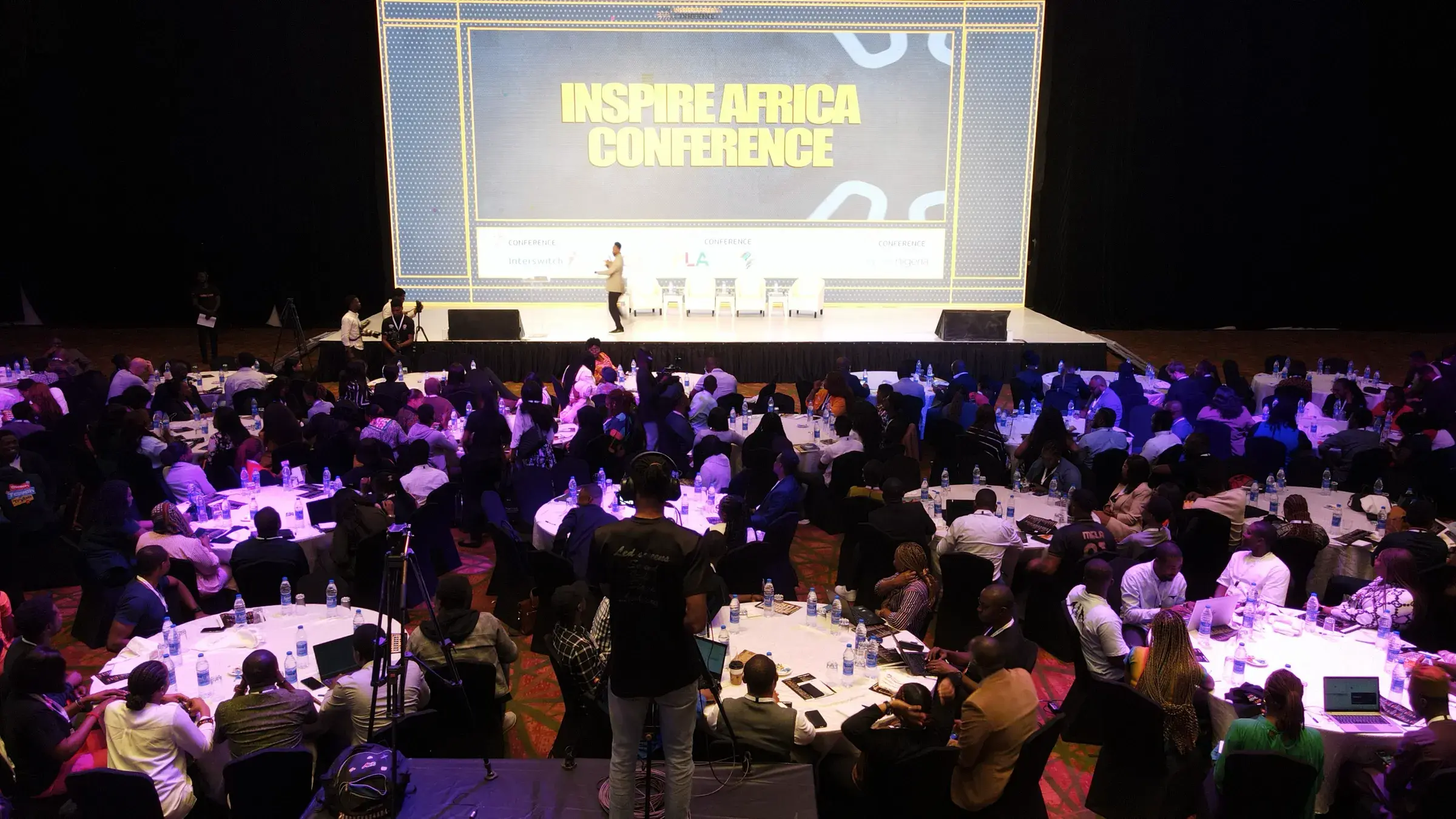 The Inspire Africa Conference hall from above, delegates at round tables facing the stage