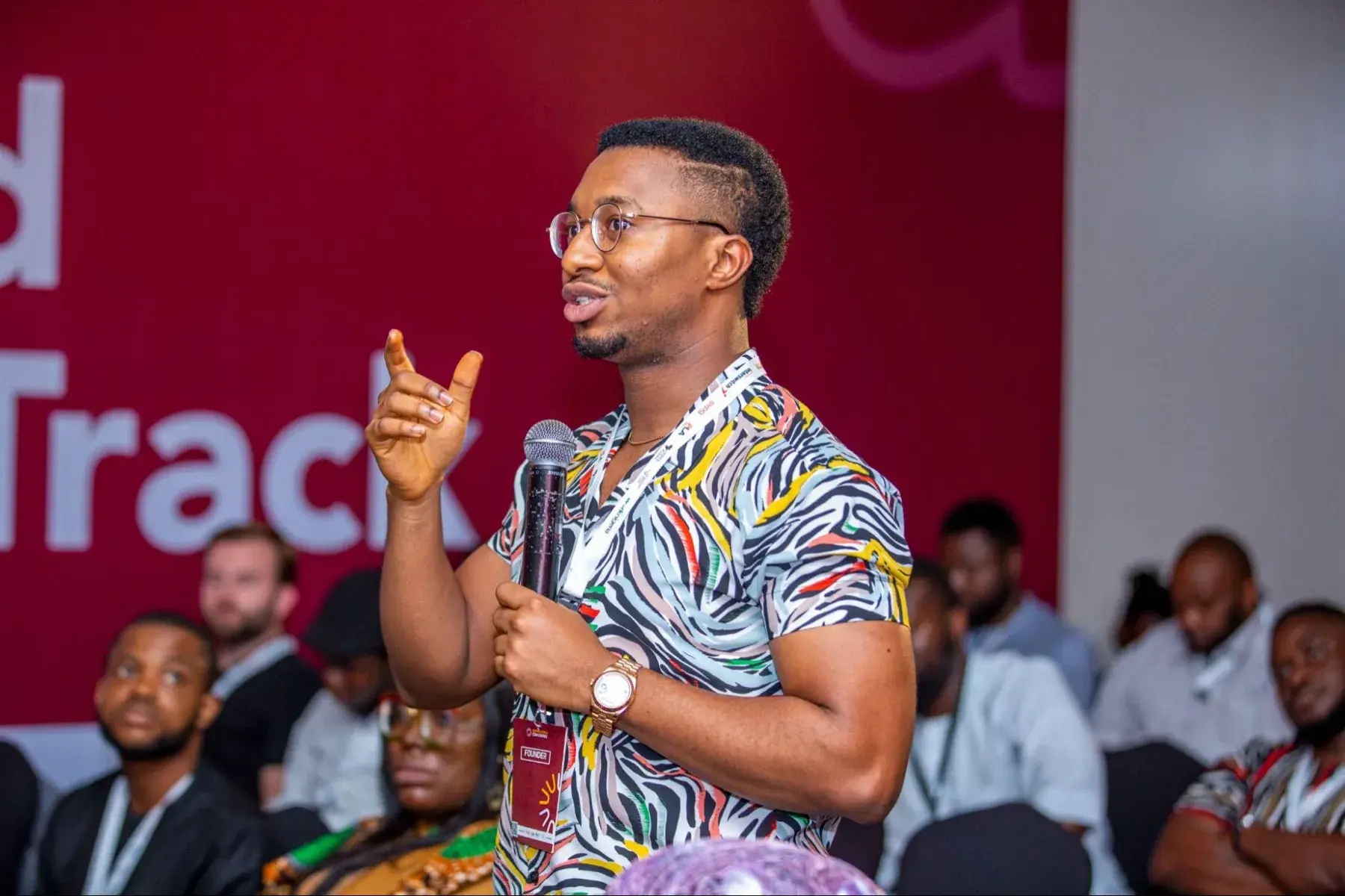 A founder presenting on stage at the conference